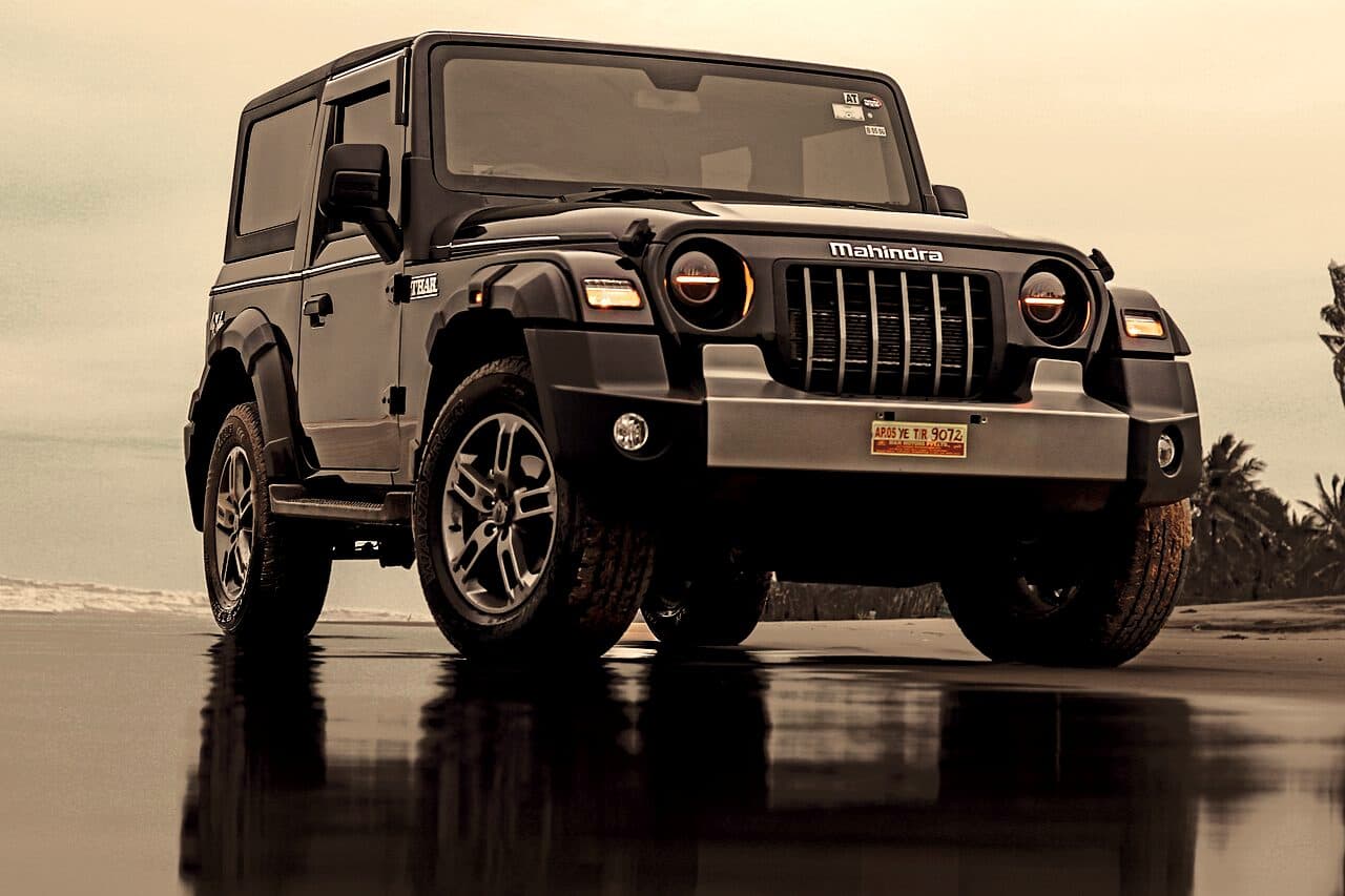 Mahindra Thar parked beside an open coastal road